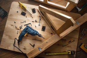 Woodworking tools and a partially assembled furniture piece on a workbench, symbolizing home improvement as a smart investment for a lump sum.